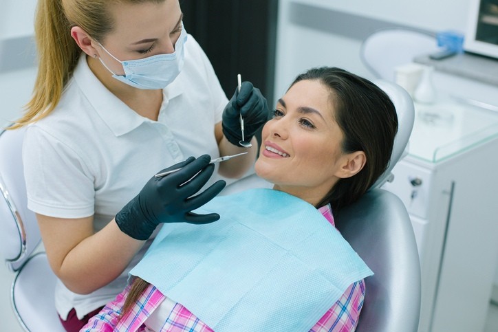 Dentist checking patient's teeth to show Importance of Regular Dental Check-Ups in Brecksville, OH